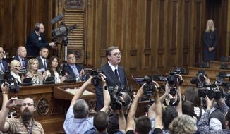 Aleksandar Vucic, the president of Serbia, center, prepares to speak during a session of Serbia&#39;s parliament in Belgrade, Serbia, Monday, May 27, 2019. Vucic addressed the Serb parlamentarians during a session devoted to the situation in Kosovo, which declared independence from Serbia in 2008. (AP Photo/Marko Drobnjakovic)