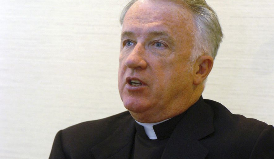 FILE - This Feb. 21, 2005 file photo, shows incoming bishop of the Wheeling-Charleston diocese, W.Va, Michael Bransfield in his new office, in Wheeling, W.Va. West Virginia's Roman Catholic diocese has released the names of nine more priests who it said have been credibly accused of child sexual abuse. West Virginia Attorney General Patrick Morrisey in March 2019 filed a lawsuit accusing the diocese and former Bishop Michael Bransfield of knowingly employing pedophiles and failing to conduct adequate background checks on camp and school workers.(AP Photo/Dale Sparks, File)