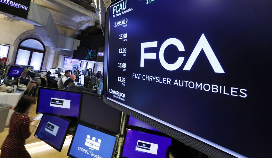 The Fiat Chrysler Automobiles logo appears above a post on the floor of the New York Stock Exchange, Tuesday, May 28, 2019. Fiat Chrysler is proposing a merger with French carmaker Renault aimed at saving billions of dollars for both companies. (AP Photo/Richard Drew)