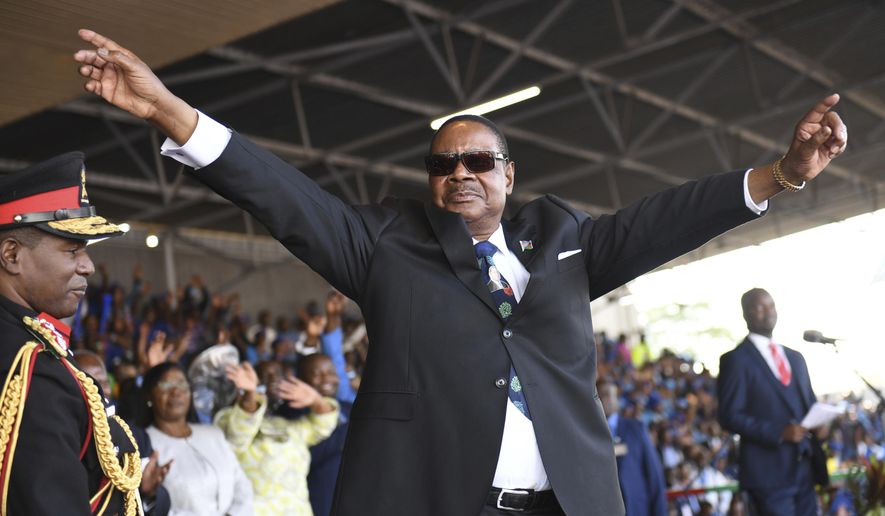 Newly elected Malawi President Peter Mutharika of The Democratic Progressive Party (DPP) waves to supporters at his swearing in ceremony at Kamuzu Stadium in Blantyre, Malawi, Tuesday May 28, 2019. Mutharika has called for unity after being sworn in for a second five-year term after an election in which opposition parties alleged irregularities. (AP Photo/Thoko Chilondi)