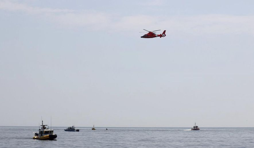 In this photo provided by the United States Coast Guard, a USCG helicopter joins vessels of both public and private origon off Cape May Point, N.J., in the search for a single engine airplane that crashed into the Atlantic Ocean, Wednesday, May 29, 2019. The aircraft's owner says the male pilot was a regular customer who flew recreationally. (Petty Officer 2nd Class Ryan Keegan/United States Coast Guard via AP)