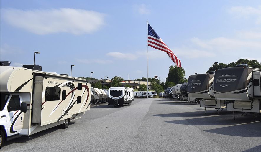 In this undated handout photo provided by Camping World, an American flag blows in the wind at Gander RV, in Statesville, N.C. A Colorado pastor is pushing back against a restriction the city of Pueblo has placed on his church regarding RV parking. He says allowing traveling ministers to park their RVs in his church parking lot and connect to utilities there has been part of his congregation’s “hospitality ministry” in place for more than 30 years. (Jennifer Munday/Camping World, AP)  **FILE**
