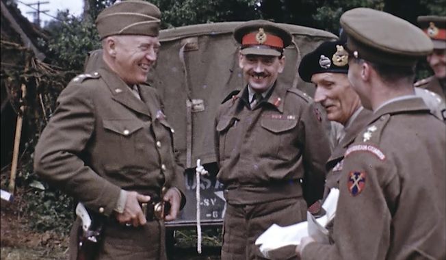 Gen. George Patton, with a pearl-handled pistol, talks to French officers in France during World War II. Years later, surprising color images of the D-Day invasion and aftermath bring an immediacy to wartime memories. They were filmed by Hollywood director George Stevens and rediscovered years after his death. (War Footage From the George Stevens Collection at the Library of Congress via AP) ** FILE **