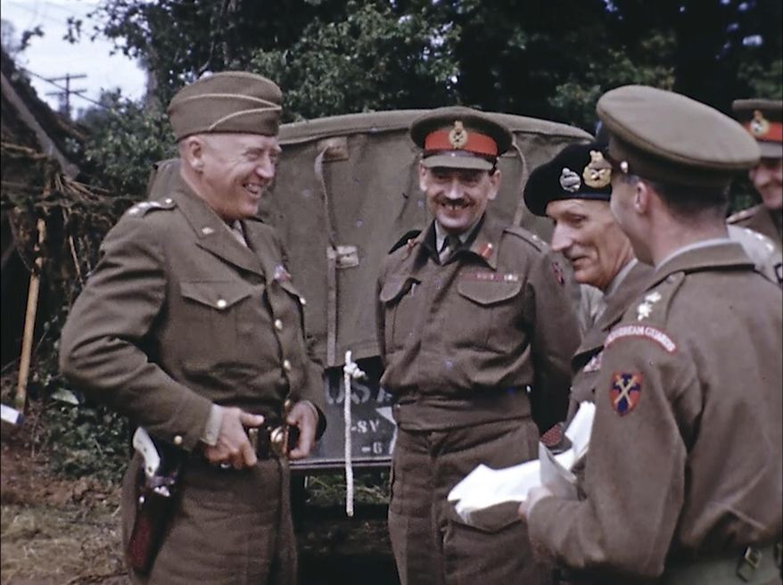 Gen. George Patton, with a pearl-handled pistol, talks to French officers in France during World War II. Years later, surprising color images of the D-Day invasion and aftermath bring an immediacy to wartime memories. They were filmed by Hollywood director George Stevens and rediscovered years after his death. (War Footage From the George Stevens Collection at the Library of Congress via AP) ** FILE **