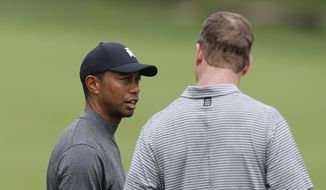 Tiger Woods, left, talks with former NFL player Peyton Manning during the pro-am round of the Memorial golf tournament Wednesday, May 29, 2019, in Dublin, Ohio. (AP Photo/Jay LaPrete)  **FILE**