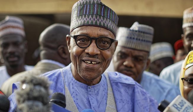 FILE - In this Saturday, Feb. 23, 2019 file photo, Nigeria&#x27;s President Muhammadu Buhari speaks to the media after casting his vote in his hometown of Daura, in northern Nigeria. Nigeria&#x27;s President Muhammadu Buhari has been sworn in for a second four-year term in Africa&#x27;s most populous country on Wednesday, May 29. The 76-year-old former military dictator faces heightened pressure to defeat Islamic extremism and boost the oil-dependent economy amid concerns over his health.(AP Photo/Ben Curtis, File)