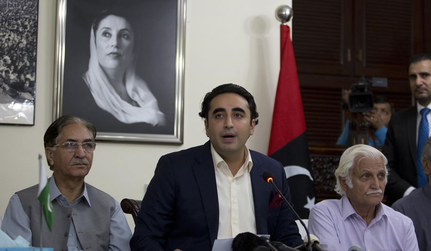 Pakistan's opposition leader Bilawal Bhutto, center, addresses a news conference in Islamabad, Pakistan, Wednesday, May 29, 2019. Bhutto condemned the government after police baton charged his supporters gathered outside the National Accountability Bureau where Bhutto appeared before a court regarding the fake accounts case. (AP Photo/B.K. Bangash)