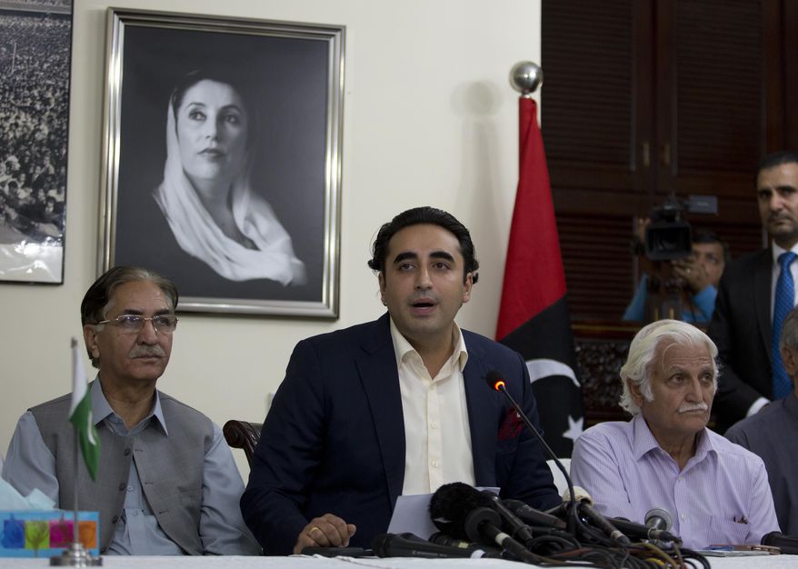Pakistan's opposition leader Bilawal Bhutto, center, addresses a news conference in Islamabad, Pakistan, Wednesday, May 29, 2019. Bhutto condemned the government after police baton charged his supporters gathered outside the National Accountability Bureau where Bhutto appeared before a court regarding the fake accounts case. (AP Photo/B.K. Bangash)