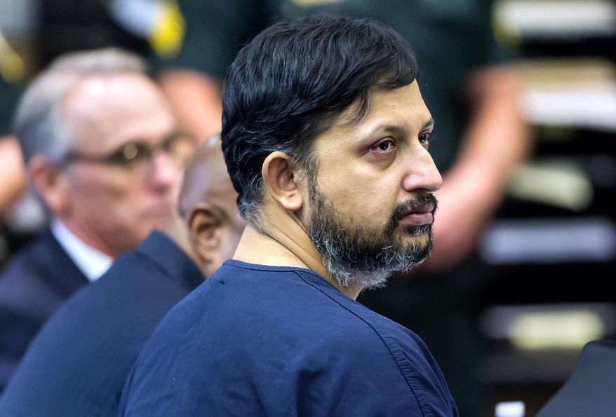 FILE - In this April 25, 2019 file photo, Nouman Raja listens to Chief Assistant State Attorney Adrienne Ellis during his sentencing hearing in West Palm Beach, Fla. An attorney for the former Florida police officer wants his client to be granted bail while his conviction for killing a black motorist is appealed. Raja’s lead attorney told Judge Richard Marx on Wednesday, May 29 that the fired Palm Beach Gardens officer has surrendered his passport and is not a flight risk. (Lannis Waters/Palm Beach Post via AP, Pool, File)