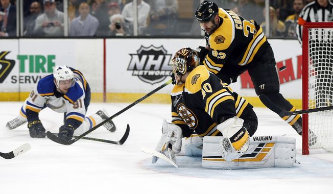 St. Louis Blues' Vladimir Tarasenko, left, of Russia, watches his shot sail puck past Boston Bruins goaltender Tuukka Rask, front, of Finland, and Zdeno Chara (33), of Slovakia, for a goal during the first period in Game 2 of the NHL hockey Stanley Cup Final, Wednesday, May 29, 2019, in Boston. (AP Photo/Michael Dwyer)