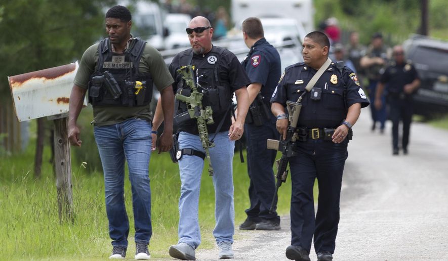 Law enforcement arrive on scene as they investigate a home where they believe the suspect's vehicle from an officer involved shooting is parked, Wednesday, May 29, 2019, in Cleveland. Police are searching for a man they say killed a woman and wounded three people, including a sheriff's deputy, during shootings in East Texas. ( Jason Fochtman/Houston Chronicle via AP)