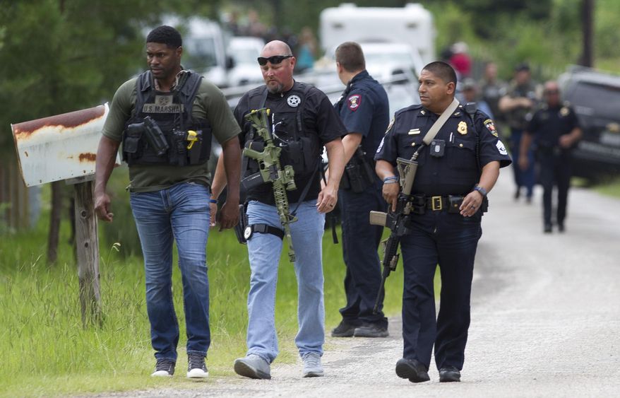 Law enforcement arrive on scene as they investigate a home where they believe the suspect's vehicle from an officer involved shooting is parked, Wednesday, May 29, 2019, in Cleveland. Police are searching for a man they say killed a woman and wounded three people, including a sheriff's deputy, during shootings in East Texas. ( Jason Fochtman/Houston Chronicle via AP)
