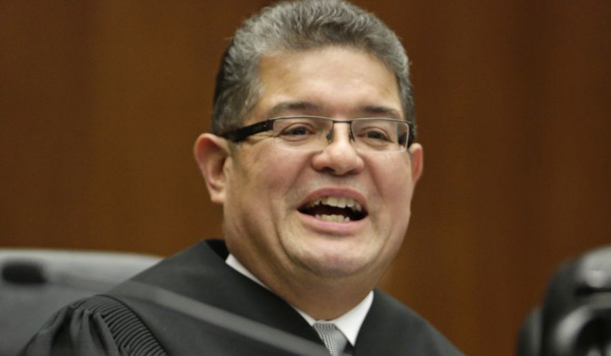 In this Nov. 25, 2013 file photo, Chief U.S. District Judge Ruben Castillo speaks from the bench in Chicago. Castillo is slated to issue a first-in-the-nation ruling Monday, March 12, 2018, about whether law enforcement stings where suspects are talked into robbing non-existent drugs from non-existent stash houses are racially biased. (AP Photo/M. Spencer Green, File)