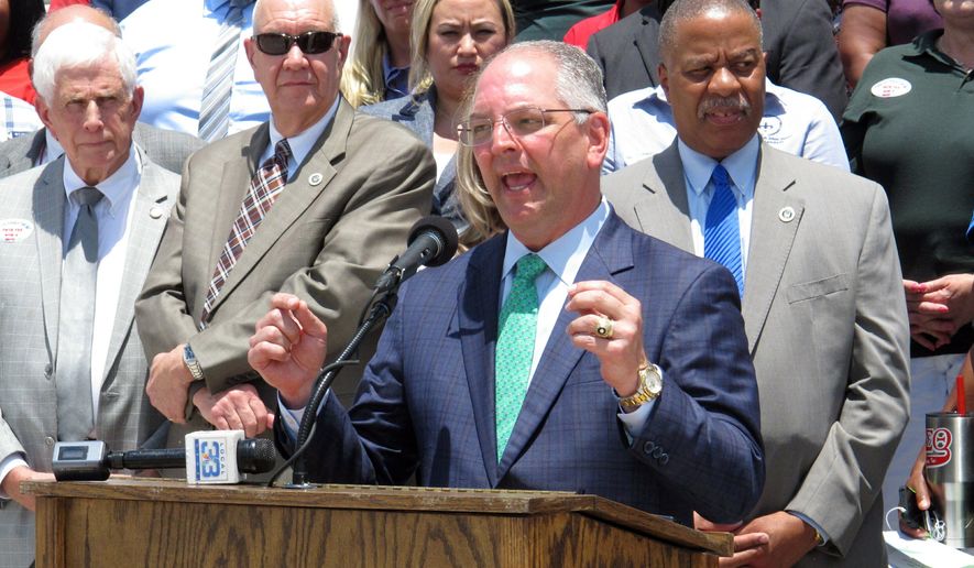 Louisiana Gov. John Bel Edwards, surrounded by public school leaders, speaks in support of the Senate version of next year&#x27;s K-12 public school financing formula, which includes a $39 million block grant increase for districts, on Wednesday, May 29, 2019, Baton Rouge, La. The House Education Committee debated the formula Thursday, May 30. (AP Photo/Melinda Deslatte)