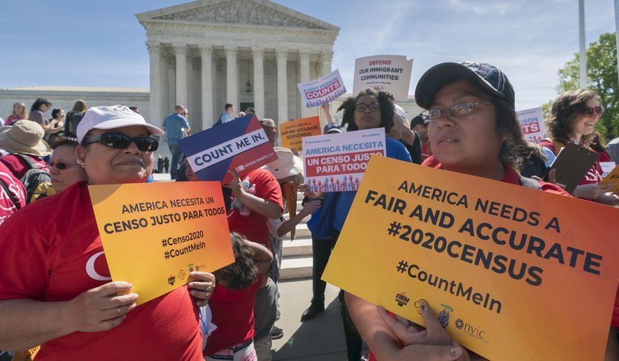 FILE - In this April 23, 2019 file photo, immigration activists rally outside the Supreme Court as the justices hear arguments over the Trump administration&#39;s plan to ask about citizenship on the 2020 census, in Washington. A new court filing Thursday, May 30 by lawyers opposing adding the citizenship question to the 2020 census alleges a longtime Republican redistricting expert played a key role in making the change. (AP Photo/J. Scott Applewhite, File)