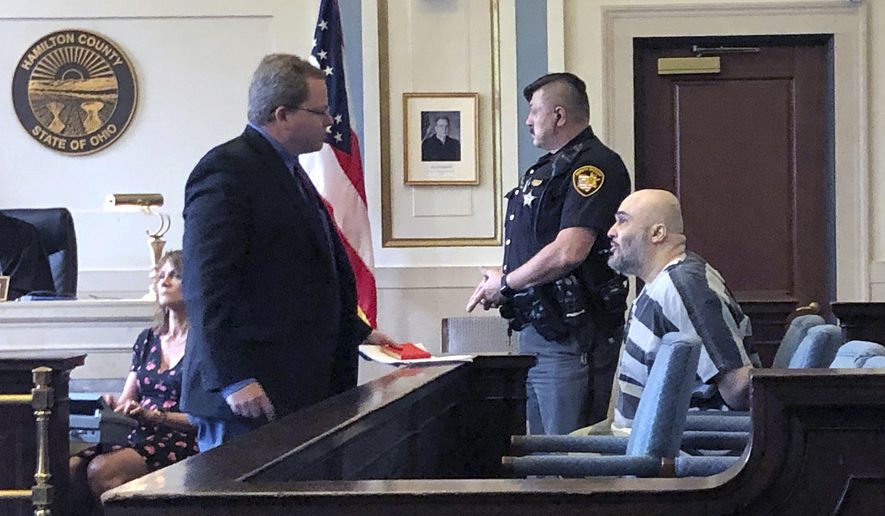 Ahmad Fawzi Issa, right, sits in Hamilton County Court Thursday May 30, 2019 in Cincinnati. Issa, 49, who was sentenced to death in 1998, appeared before a county judge after a federal appeals court threw out his conviction. Issa pleaded not guilty to aggravated murder in Hamilton County and will remain jailed without bond pending resolution of his case. Heis now off Ohio's death row after more than 20 years because his conviction was tossed is back in court and likely facing deportation to his native Jordan. (AP Photo/Dan Sewell)