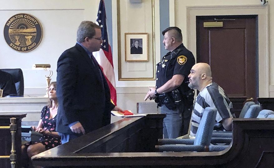 Ahmad Fawzi Issa, right, sits in Hamilton County Court Thursday May 30, 2019 in Cincinnati. Issa, 49, who was sentenced to death in 1998, appeared before a county judge after a federal appeals court threw out his conviction. Issa pleaded not guilty to aggravated murder in Hamilton County and will remain jailed without bond pending resolution of his case. Heis now off Ohio's death row after more than 20 years because his conviction was tossed is back in court and likely facing deportation to his native Jordan. (AP Photo/Dan Sewell)
