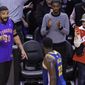 Rapper Drake, left,, says something to Golden State Warriors forward Draymond Green (23) after the Toronto Raptors defeated the Warriors in Game 1 of basketball’s NBA Finals, Thursday, May 30, 2019, in Toronto. (Nathan Denette/The Canadian Press via AP)