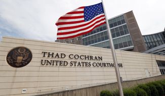 An American flag flies at half-staff for former Mississippi U.S. Sen. Thad Cochran, outside the Thad Cochran United States Courthouse, named in his honor last year, in downtown Jackson, Miss., Thursday, May 30, 2019. Cochran died early Thursday morning, in Oxford, according to his former congressional office. He was 81. (AP Photo/Rogelio V. Solis, File)