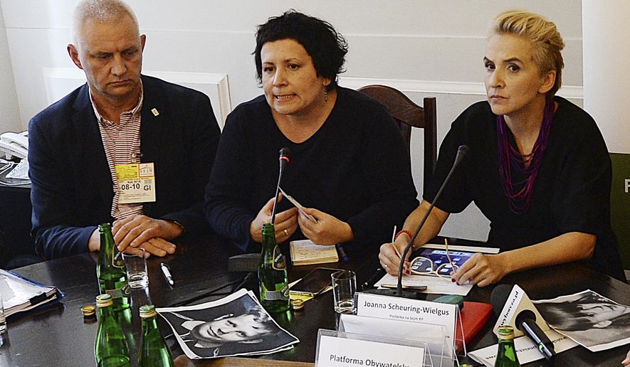 FILE - In this Oct. 8, 2018 file photo, head of a Polish organization "Have No Fear", representing victims of pedophile priests, Marek Lisinski left, sits with activist Agata Diduszko-Zyglewska, center, and opposition lawmaker Joanna Scheuring-Wielgus during a meeting that demanded strict criminal punishment for pedophile priests at the parliament in Warsaw, Poland. A Polish daily newspaper reported on Thursday, May 30, 2019 that Lisinski resigned after allegations surfaced that he tried to extort money from a victim and demanded money from the producers of a documentary about clerical abuse. (AP Photo/Czarek Sokolowski, file)