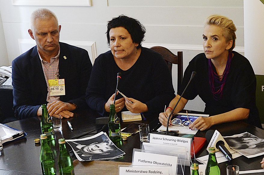 FILE - In this Oct. 8, 2018 file photo, head of a Polish organization "Have No Fear", representing victims of pedophile priests, Marek Lisinski left, sits with activist Agata Diduszko-Zyglewska, center, and opposition lawmaker Joanna Scheuring-Wielgus during a meeting that demanded strict criminal punishment for pedophile priests at the parliament in Warsaw, Poland. A Polish daily newspaper reported on Thursday, May 30, 2019 that Lisinski resigned after allegations surfaced that he tried to extort money from a victim and demanded money from the producers of a documentary about clerical abuse. (AP Photo/Czarek Sokolowski, file)