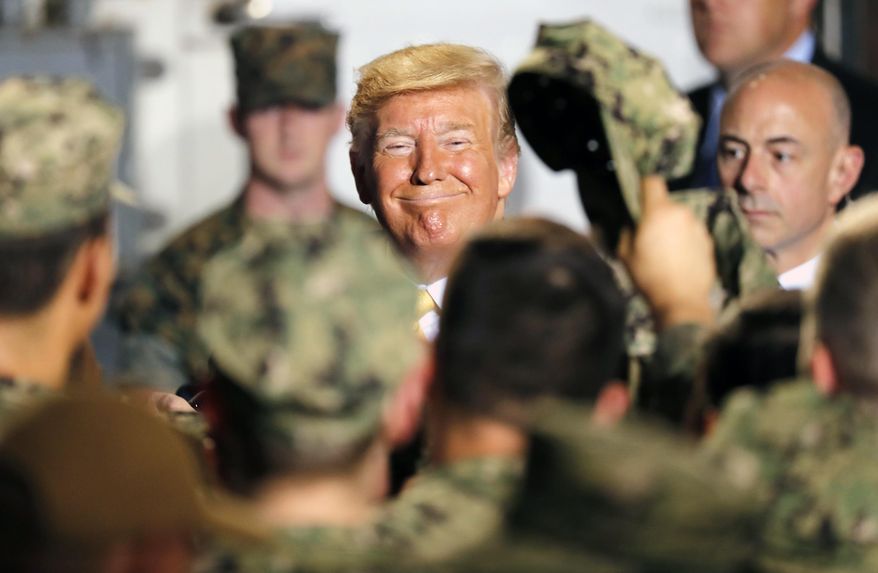 In this Tuesday, May 28, 2019, file photo, U.S. President Donald Trump greets to U.S. servicemen at U.S. Navy multipurpose amphibious assault ship USS Wasp at the U.S. Navy's Yokosuka base in Yokosuka, south of Tokyo. (AP Photo/Eugene Hoshiko, File)
