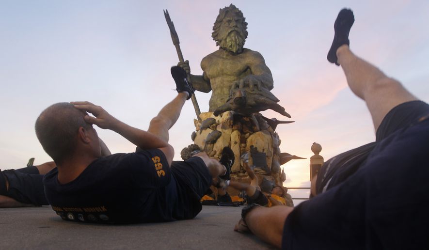U.S. Navy Chief Petty Officers conduct physical training in front of a statue of Neptune on the oceanfront of Virginia Beach, Va., Friday, Aug. 26, 2011. (AP Photo/Steve Helber) **FILE**