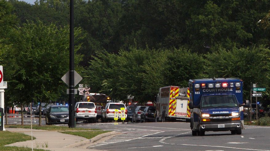 Emergency vehicle are seen near the intersection of Princess Anne Road and Nimmo Parkway following a shooting at the Virginia Beach Municipal Center on Friday, May 31, 2019 in Virginia Beach, Va. At least one shooter wounded multiple people at a municipal center in Virginia Beach on Friday, according to police, who said a suspect has been taken into custody. (Kaitlin McKeown/The Virginian-Pilot via AP)