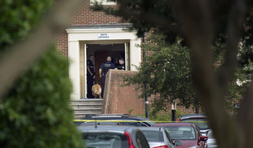 Police work the scene where eleven people were killed during a mass shooting at the Virginia Beach city public works building, Friday, May 31, 2019 in Virginia Beach, Va. A longtime, disgruntled city employee opened fire at a municipal building in Virginia Beach on Friday, killing 11 people before police fatally shot him, authorities said. Six other people were wounded in the shooting, including a police officer whose bulletproof vest saved his life, said Virginia Beach Police Chief James Cervera. (L. Todd Spencer/The Virginian-Pilot via AP)