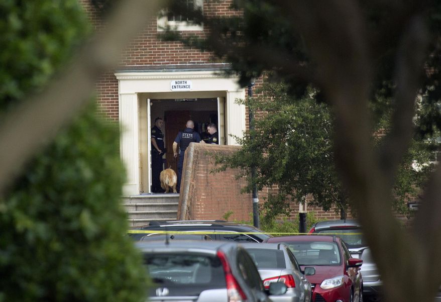 Police work the scene where eleven people were killed during a mass shooting at the Virginia Beach city public works building, Friday, May 31, 2019 in Virginia Beach, Va. A longtime, disgruntled city employee opened fire at a municipal building in Virginia Beach on Friday, killing 11 people before police fatally shot him, authorities said. Six other people were wounded in the shooting, including a police officer whose bulletproof vest saved his life, said Virginia Beach Police Chief James Cervera. (L. Todd Spencer/The Virginian-Pilot via AP)