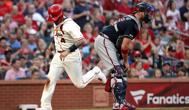 St. Louis Cardinals&#x27; Yadier Molina (4) scores past Atlanta Braves catcher Tyler Flowers during the fifth inning of a baseball game Saturday, May 25, 2019, in St. Louis. (AP Photo/Jeff Roberson)