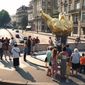 FILE  - In this Thursday, Aug. 31, 2000 file photo, people gather around the gilded statue modeled on the flame of the Statue of Liberty that serves as an unofficial shrine to Princess Diana above the traffic tunnel where she died three years ago in Paris. Paris City Hall wants to name a small plaza after Princess Diana, at the site of the 1997 car crash that killed the cherished British royal. The site already holds a golden flame-shaped monument in her honor, adjacent to the Alma Tunnel where the accident occurred.  (AP Photo/William Alix, File)