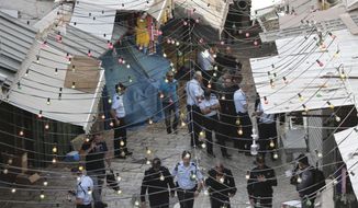 Israeli police officers gather at the scene of a stabbing attack near the Damascus Gate in Jerusalem&#39;s Old City, Friday, May 31, 2019. The incident occurred just hours before weekly Friday prayers at the nearby Al-Aqsa Mosque, when tens of thousands of people are expected for Ramadan prayers. (AP Photo/Mahmoud Illean)
