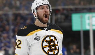 Boston Bruins center Sean Kuraly celebrates after scoring against the St. Louis Blues during the first period of Game 3 of the NHL hockey Stanley Cup Final Saturday, June 1, 2019, in St. Louis. (AP Photo/Jeff Roberson)