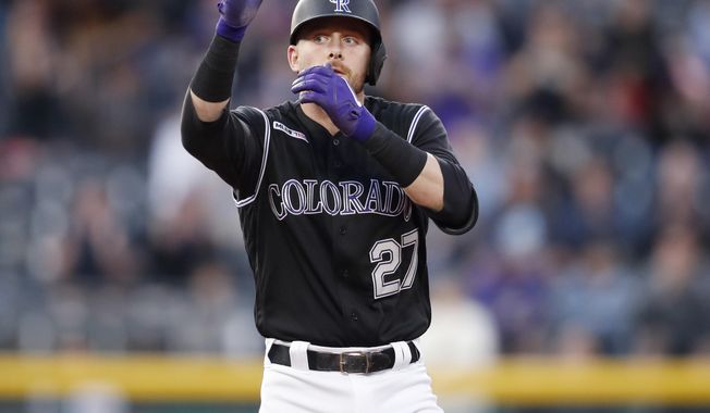 Colorado Rockies&#x27; Trevor Story gestures to the dugout after hitting a double to drive in three runs off Toronto Blue Jays starting pitcher Edwin Jackson in the third inning of a baseball game Friday, May 31, 2019, in Denver. (AP Photo/David Zalubowski)