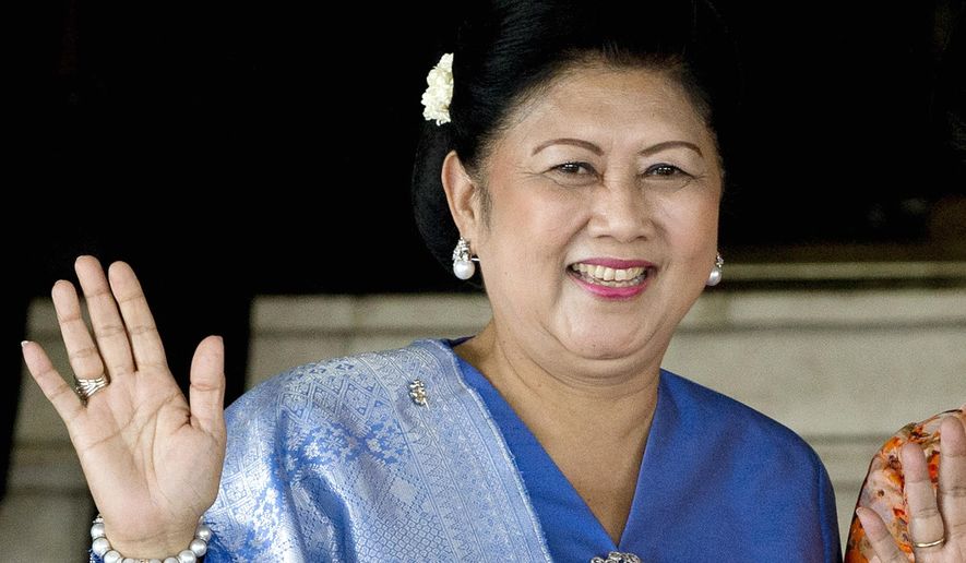 FILE - In this Oct. 20, 2014, file photo, former Indonesian first lady Kristiani Yudhoyono waves at reporters after attending an event at the parliament in Jakarta, Indonesia. Kristiani, the wife of Indonesia's sixth President Susilo Bambang Yudhoyono, has died on Saturday, June 1, 2019, in Singapore where she had been treated for cancer for several months. She was 66. (AP Photo/Mark Baker, File)