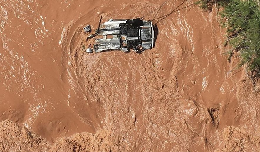 In this Friday, May 31, 2019 photo released by the Beaver Dam Littlefield Fire District shows an upside down vehicle in the Virgin River along Interstate 15 by bridge 7 near Littlefield, Ariz. Authorities say a Utah man sought in an alleged sex crime involving a juvenile is missing after his car went into a river in a northwestern Arizona gorge. Police in Hurricane, Utah, said in a statement that the man's car was spotted upside down after officers broke off a pursuit after the car entered Arizona. (Capt. Deborah Gates/Beaver Dam Littlefield Fire District Department via AP)