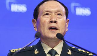 Chinese Defense Minister Gen. Wei Fenghe speaks during the fourth plenary session of the 18th International Institute for Strategic Studies (IISS) Shangri-la Dialogue, an annual defense and security forum in Asia, in Singapore, Sunday, June 2, 2019. (AP Photo/Yong Teck Lim)