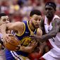 Golden State Warriors guard Stephen Curry (30) tries to fend off Toronto Raptors guard Fred VanVleet (23) and teammate Pascal Siakam (43) during the second half of Game 2 of basketballs NBA Finals, Sunday, June 2, 2019, in Toronto. (Frank Gunn/The Canadian Press via AP)