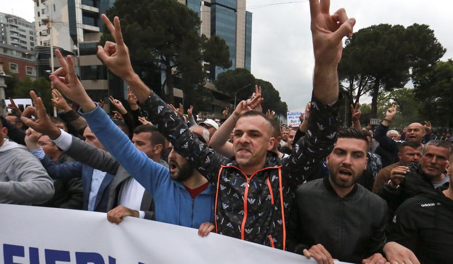 Protesters take part in an anti-government rally in Tirana, Sunday June 2, 2019. Albanian opposition supporters have mounted a new anti-government protest asking for fresh elections, despite repeated calls from the western powers. (AP Photo/Hektor Pustina)