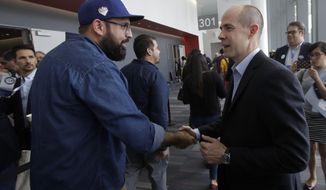 Rusty Hicks, a candidate for Chair of the California Democratic Party, right, shakes hands with a supporter during the 2019 California Democratic Party State Organizing Convention in San Francisco, Saturday, June 1, 2019. Hicks was elected chairman of the state party Saturday night by thousands of activists at the party’s annual convention. (AP Photo/Jeff Chiu)