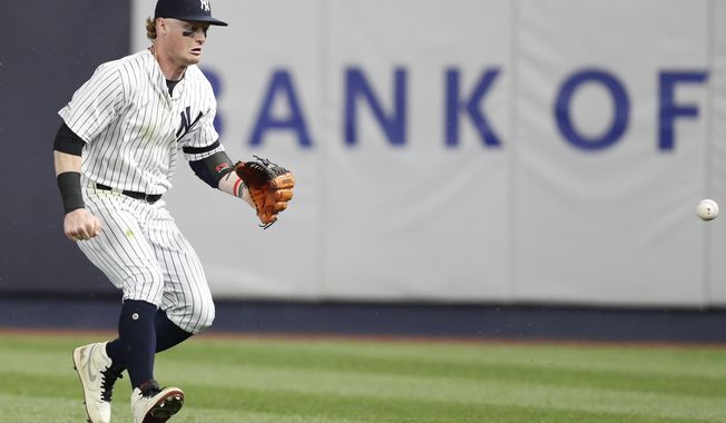 New York Yankees right fielder Clint Frazier goes after Boston Red Sox Michael Chavis&#x27;s RBI triple as it bounces away from him during the eighth inning of a baseball game, Sunday, June 2, 2019, in New York. (AP Photo/Kathy Willens)