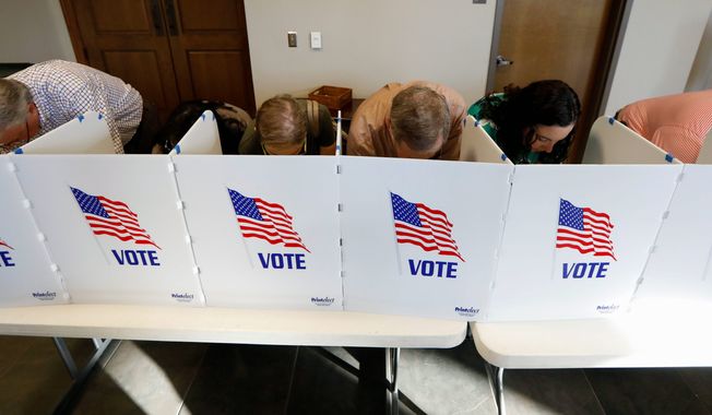 Every voting booth was filled by Madison County voters Tuesday, Nov. 6, 2018, as they filled out their paper ballots in Ridgeland, Miss. Voters have a number of races to consider, including judiciary and federal offices and some local issues. (AP Photo/Rogelio V. Solis)