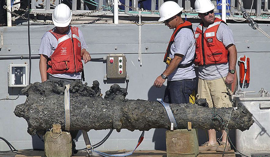FIEL - In this Oct. 26, 2011, file photo, researchers led by the N.C. Department of Cultural Resources' Underwater Archaeology Branch rest a recovered 2,000-pound cannon on the back of a NOAA research vessel from the wreck of the pirate Blackbeard's ship, which has been on the ocean floor off the North Carolina coast for nearly 300 years in Beaufort, N.C. The Supreme Court has agreed to hear a copyright dispute that grew out of the discovery of the pirate Blackbeard’s ship off North Carolina’s coast. (Chuck Beckley/The Jacksonville Daily News via AP)