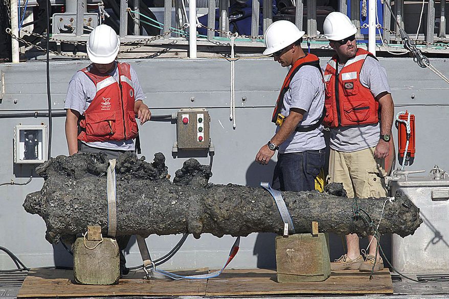 FIEL - In this Oct. 26, 2011, file photo, researchers led by the N.C. Department of Cultural Resources' Underwater Archaeology Branch rest a recovered 2,000-pound cannon on the back of a NOAA research vessel from the wreck of the pirate Blackbeard's ship, which has been on the ocean floor off the North Carolina coast for nearly 300 years in Beaufort, N.C. The Supreme Court has agreed to hear a copyright dispute that grew out of the discovery of the pirate Blackbeard’s ship off North Carolina’s coast. (Chuck Beckley/The Jacksonville Daily News via AP)
