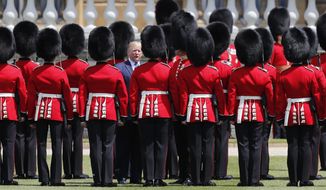 President Donald Trump reviews an honor guard during a ceremonial welcome in the garden of Buckingham Palace in London, Monday, June 3, 2019 on the opening day of a three day state visit to Britain. (AP Photo/Frank Augstein)