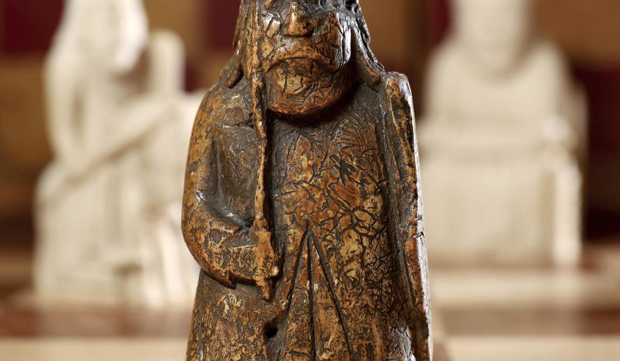 This image made available by Sotheby's on Monday June 3, 2019, shows a newly discovered Lewis Chessman on display at Sotheby's in London. The medieval chess piece purchased for five pounds by an antiques dealer in Scotland in 1964 has been found to be one of the famous medieval Lewis Chessmen and is expected to bring more than 600,000 pounds when auctioned by Sotheby’s on July 2. (Tristan Fewings/Sotheby's via AP)