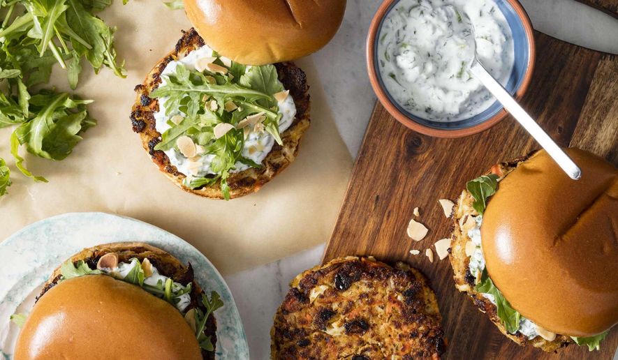 This undated photo provided by America's Test Kitchen in May 2019 shows Spiced Cauliflower Burgers with Yogurt Sauce in Brookline, Mass. This recipe appears in the cookbook "The Ultimate Burger." (Daniel J. van Ackere/America's Test Kitchen via AP)