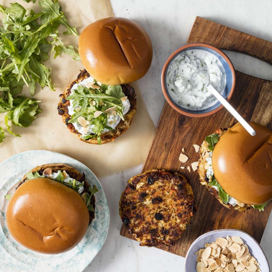 This undated photo provided by America's Test Kitchen in May 2019 shows Spiced Cauliflower Burgers with Yogurt Sauce in Brookline, Mass. This recipe appears in the cookbook "The Ultimate Burger." (Daniel J. van Ackere/America's Test Kitchen via AP)