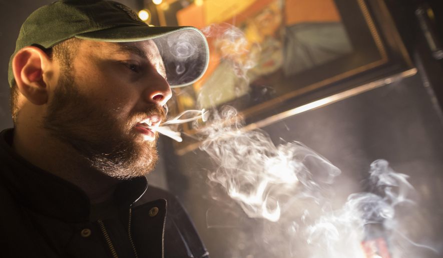 In this March 29, 2019, photo, a man smokes marijuana at a Spleef NYC canna-cocktail party in New York. (AP Photo/Mary Altaffer) **FILE**